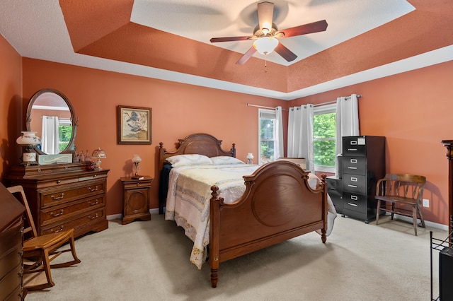 220 Deer Path Ln, Battle Creek, MI 49015 - bedroom featuring a tray ceiling, light colored carpet, and ceiling fan
