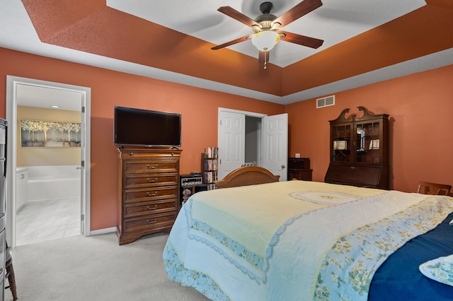 220 Deer Path Ln, Battle Creek, MI 49015 - bedroom with ensuite bathroom, a ceiling fan, and light carpet