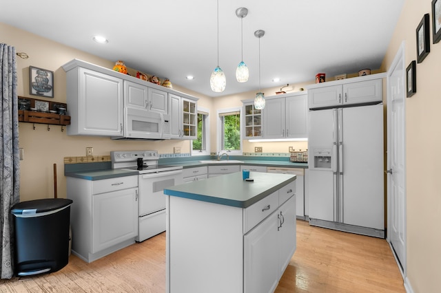 220 Deer Path Ln, Battle Creek, MI 49015 - kitchen with white appliances, light wood-type flooring, glass insert cabinets, a center island, and recessed lighting