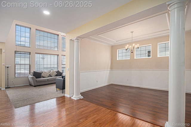 27455 Harrington Way, Novi, MI 48374 - empty room with ornate columns, hardwood / wood-style floors, a chandelier, and recessed lighting