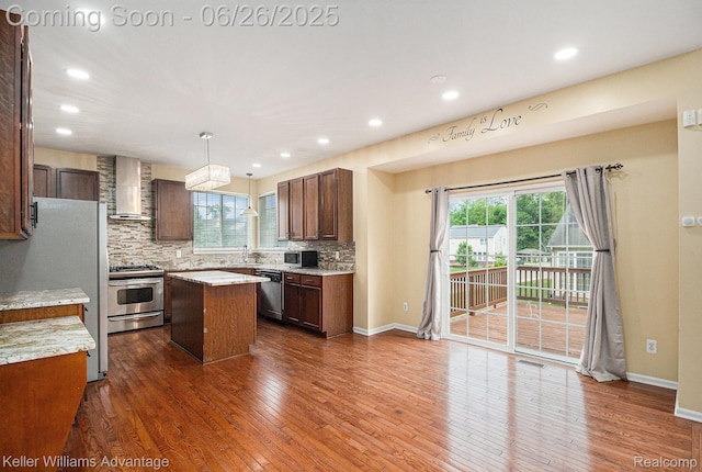 27455 Harrington Way, Novi, MI 48374 - kitchen with stainless steel appliances, wall chimney exhaust hood, a kitchen island, healthy amount of natural light, and recessed lighting
