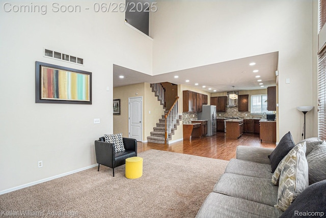 27455 Harrington Way, Novi, MI 48374 - carpeted living room with recessed lighting, stairway, and a towering ceiling