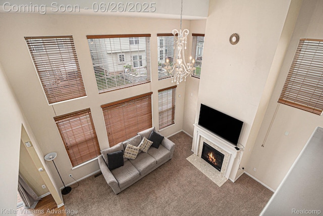 27455 Harrington Way, Novi, MI 48374 - carpeted living area featuring a high ceiling, a chandelier, and a fireplace with flush hearth