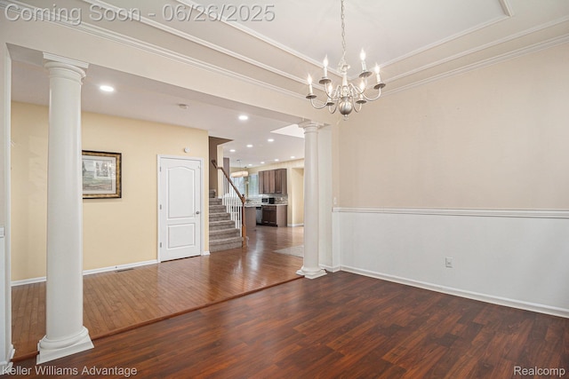 27455 Harrington Way, Novi, MI 48374 - unfurnished dining area featuring decorative columns, dark wood finished floors, crown molding, stairs, and a chandelier