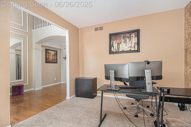 27455 Harrington Way, Novi, MI 48374 - office area featuring arched walkways, carpet flooring, and wood finished floors