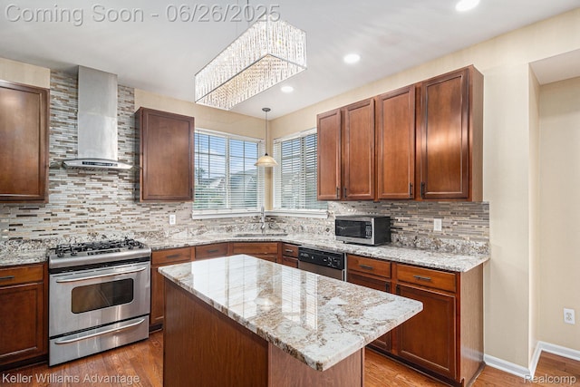 27455 Harrington Way, Novi, MI 48374 - kitchen featuring stainless steel appliances, wall chimney exhaust hood, tasteful backsplash, wood finished floors, and light stone counters