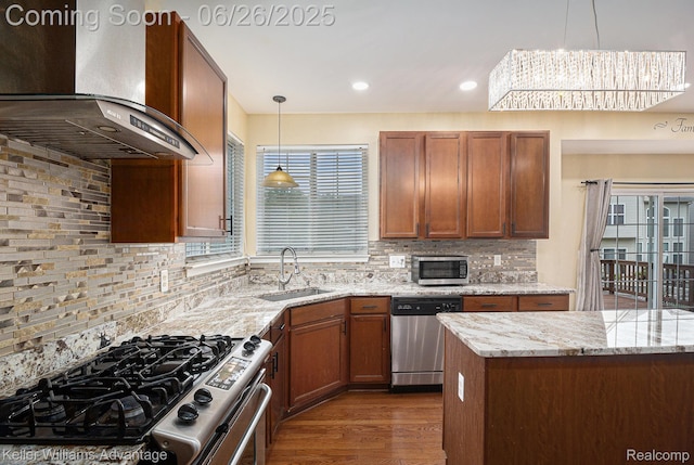 27455 Harrington Way, Novi, MI 48374 - kitchen with wall chimney exhaust hood, stainless steel appliances, tasteful backsplash, hanging light fixtures, and recessed lighting