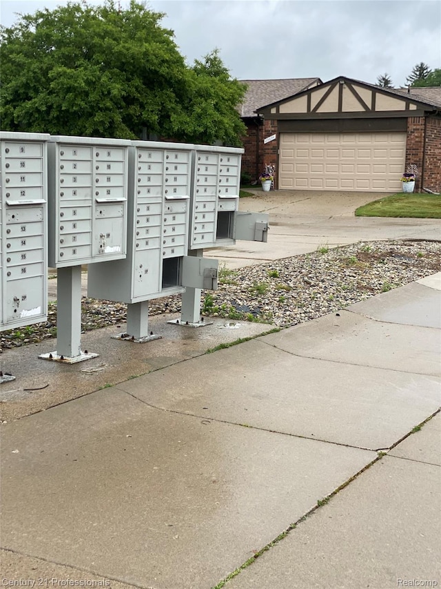 29900 N Grand Oaks Dr Unit 26, Warren, MI 48092 - view of community with mail area, driveway, and an attached garage