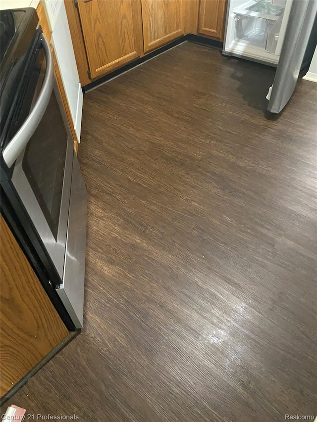 29900 N Grand Oaks Dr Unit 26, Warren, MI 48092 - kitchen view of dark wood-style floors, brown cabinetry, and stove