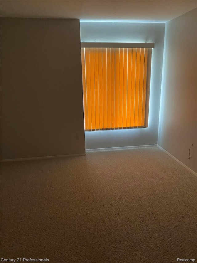 29900 N Grand Oaks Dr Unit 26, Warren, MI 48092 - spare room featuring carpet flooring and baseboards