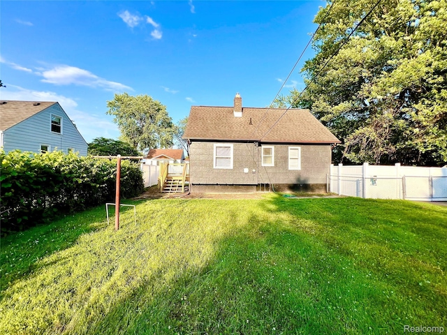 23657 Hill Ave, Warren, MI 48091 - back of house featuring a chimney and roof with shingles