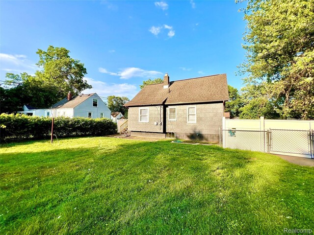 23657 Hill Ave, Warren, MI 48091 - rear view of house with a chimney and a shingled roof