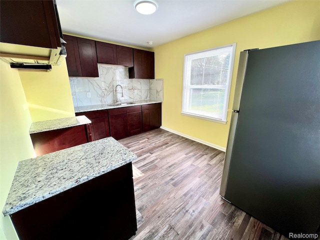 23657 Hill Ave, Warren, MI 48091 - kitchen with freestanding refrigerator, backsplash, wood finished floors, and light stone counters