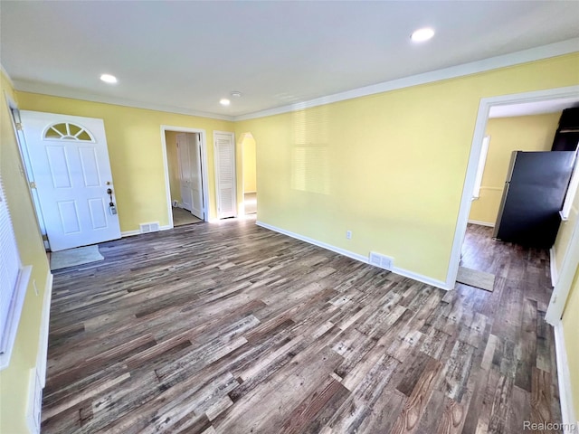23657 Hill Ave, Warren, MI 48091 - unfurnished room featuring dark wood-style flooring, arched walkways, crown molding, and recessed lighting