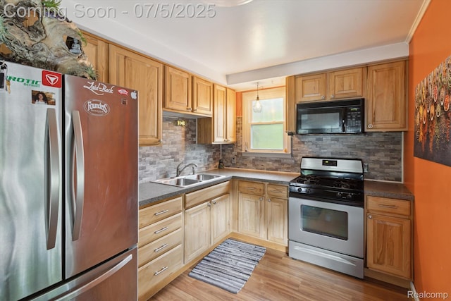 8025 Mayfair St, Taylor, MI 48180 - kitchen with appliances with stainless steel finishes, tasteful backsplash, dark countertops, light wood-type flooring, and hanging light fixtures