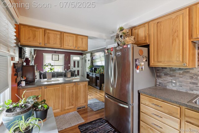 8025 Mayfair St, Taylor, MI 48180 - kitchen featuring freestanding refrigerator, light wood-style floors, plenty of natural light, decorative backsplash, and crown molding
