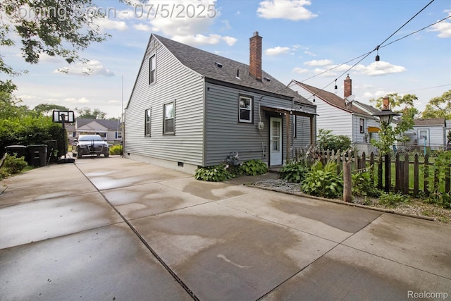 8025 Mayfair St, Taylor, MI 48180 - back of property with driveway, a shingled roof, and a chimney