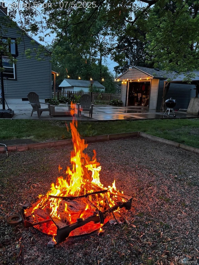 8025 Mayfair St, Taylor, MI 48180 - view of yard with an outdoor fire pit, a shed, and a detached garage