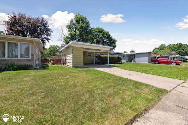3606 Pingree Ave, Flint, MI 48503 - view of front facade with driveway, a front lawn, and a carport