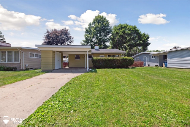 3606 Pingree Ave, Flint, MI 48503 - view of front of house with driveway, a front lawn, an attached carport, and a chimney
