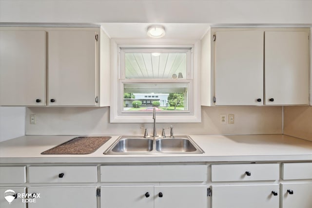 3606 Pingree Ave, Flint, MI 48503 - kitchen featuring light countertops and white cabinets