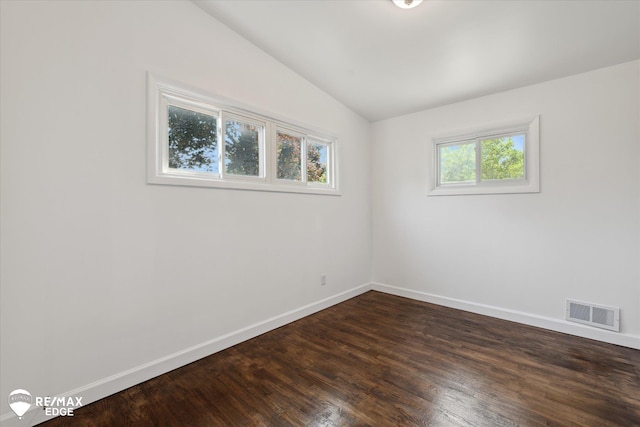 3606 Pingree Ave, Flint, MI 48503 - spare room featuring vaulted ceiling and dark wood-style flooring