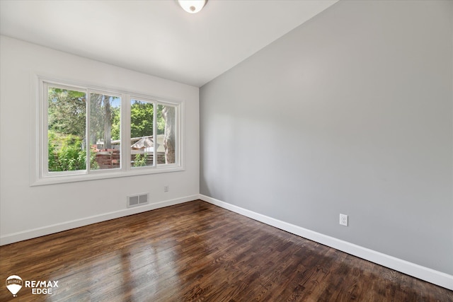 3606 Pingree Ave, Flint, MI 48503 - spare room with dark wood finished floors and vaulted ceiling