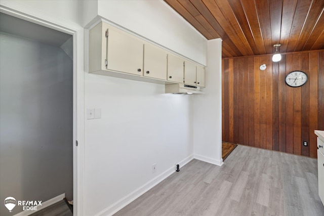 3606 Pingree Ave, Flint, MI 48503 - laundry area featuring wooden ceiling, light wood-style floors, wood walls, and cabinet space