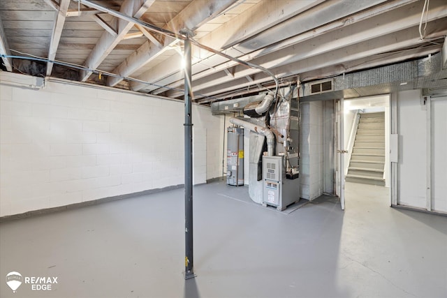 3606 Pingree Ave, Flint, MI 48503 - unfinished basement with heating unit, water heater, stairway, and concrete block wall