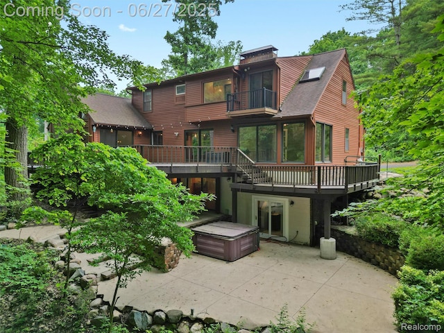 9767 Whisperwood Ln, Brighton, MI 48116 - back of property featuring a balcony, a patio, a deck, and a shingled roof