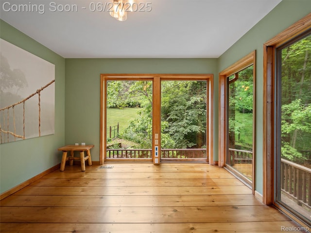 9767 Whisperwood Ln, Brighton, MI 48116 - empty room with plenty of natural light and hardwood / wood-style floors