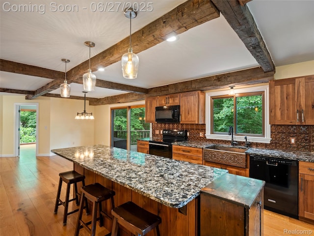 9767 Whisperwood Ln, Brighton, MI 48116 - kitchen with black appliances, a kitchen island, tasteful backsplash, light wood finished floors, and beam ceiling
