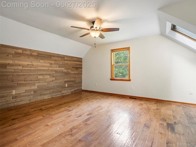 9767 Whisperwood Ln, Brighton, MI 48116 - additional living space featuring vaulted ceiling, ceiling fan, and wood-type flooring