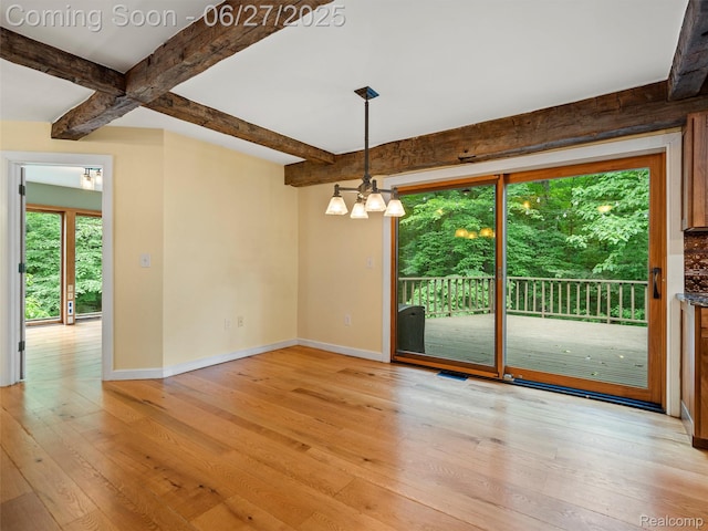 9767 Whisperwood Ln, Brighton, MI 48116 - unfurnished room with beam ceiling, light wood-style floors, and a chandelier