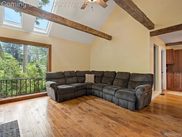 9767 Whisperwood Ln, Brighton, MI 48116 - living room featuring beamed ceiling, wood-type flooring, a skylight, high vaulted ceiling, and a ceiling fan