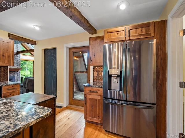 9767 Whisperwood Ln, Brighton, MI 48116 - kitchen featuring stainless steel fridge, light wood-type flooring, brown cabinetry, backsplash, and beamed ceiling