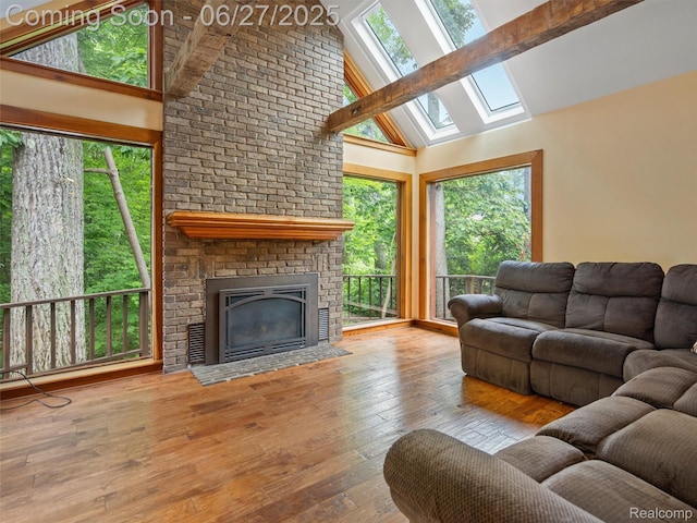 9767 Whisperwood Ln, Brighton, MI 48116 - living area with a skylight, wood-type flooring, high vaulted ceiling, a fireplace, and beam ceiling