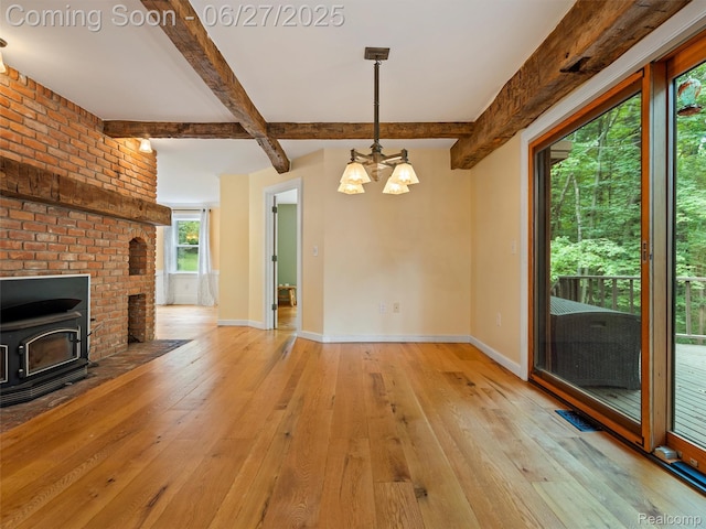 9767 Whisperwood Ln, Brighton, MI 48116 - unfurnished living room with light wood-style flooring, beamed ceiling, a chandelier, and a wood stove