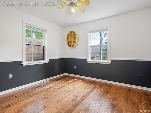 9767 Whisperwood Ln, Brighton, MI 48116 - unfurnished room featuring a ceiling fan and hardwood / wood-style flooring