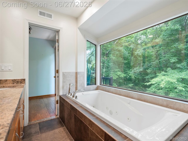 9767 Whisperwood Ln, Brighton, MI 48116 - bathroom featuring a jetted tub and vanity