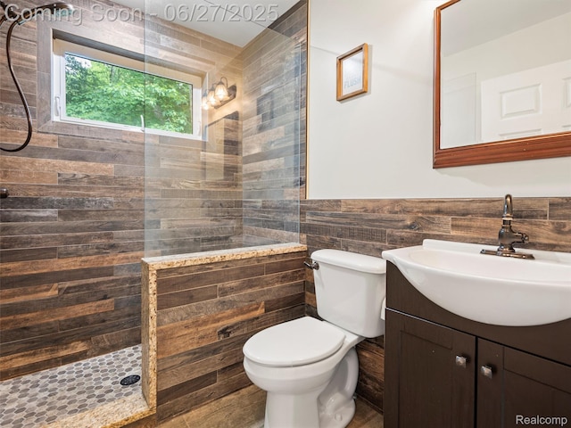 9767 Whisperwood Ln, Brighton, MI 48116 - full bathroom featuring vanity, walk in shower, wainscoting, and tile walls