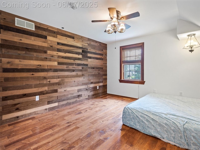 9767 Whisperwood Ln, Brighton, MI 48116 - bedroom with wood walls and wood finished floors