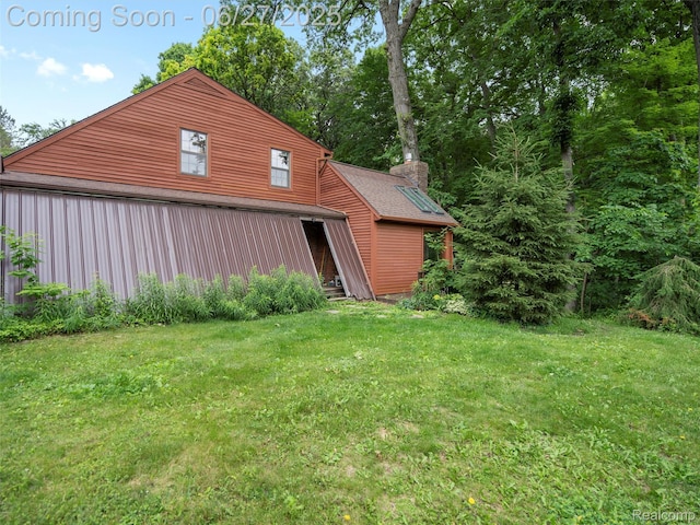 9767 Whisperwood Ln, Brighton, MI 48116 - view of side of home with a yard, an outbuilding, and an outdoor structure