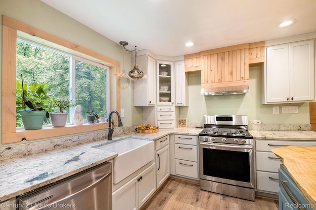 6428 W Court St, Flint, MI 48532 - kitchen with stainless steel appliances, white cabinets, light wood-style floors, under cabinet range hood, and glass insert cabinets