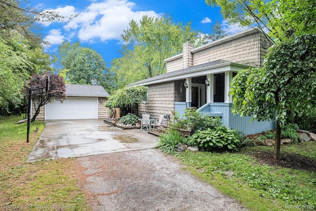 6428 W Court St, Flint, MI 48532 - view of front of house with a chimney, an outdoor structure, driveway, and a garage