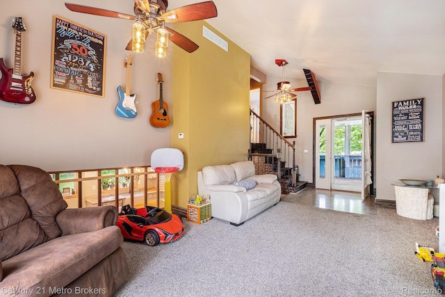 6428 W Court St, Flint, MI 48532 - carpeted living area with ceiling fan, vaulted ceiling, and stairway