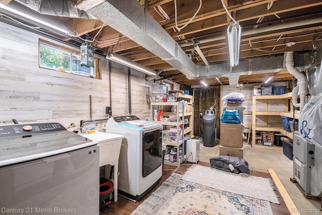 6428 W Court St, Flint, MI 48532 - below grade area with washing machine and clothes dryer, wooden walls, and a water softener system