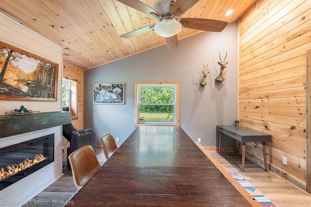 6428 W Court St, Flint, MI 48532 - dining room with lofted ceiling, wood ceiling, wood finished floors, healthy amount of natural light, and a glass covered fireplace