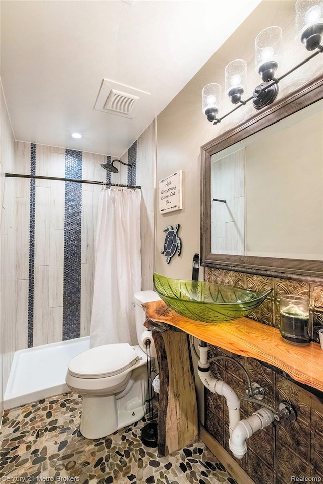 6428 W Court St, Flint, MI 48532 - full bath featuring a tile shower and stone finish floors