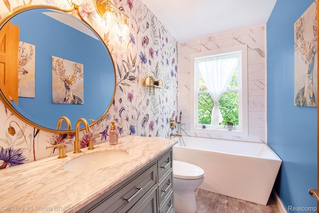 6428 W Court St, Flint, MI 48532 - full bath featuring vanity, a soaking tub, and wood finished floors